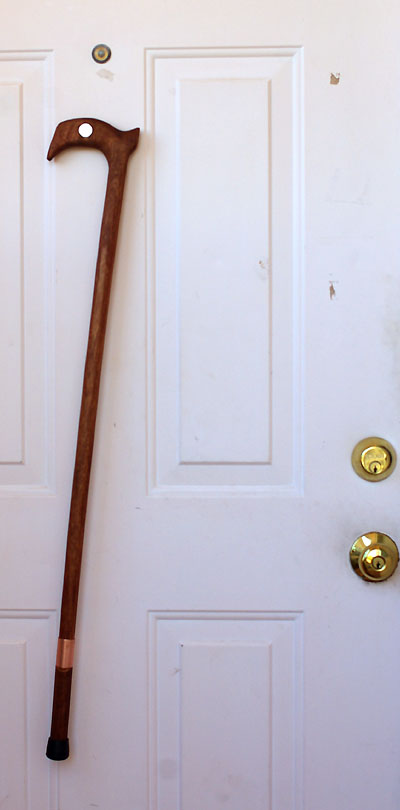 Cane clinging to front door.