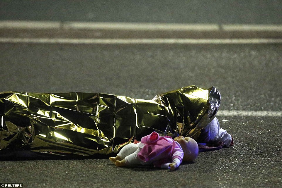 A child's doll lies on the street beside the body of a young girl who was killed in last night's attack in Nice in the south of France